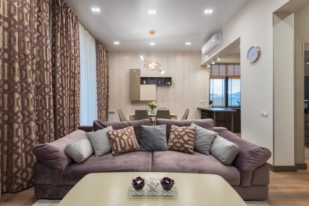 Interior of contemporary living room with soft sofa and decorative cushions