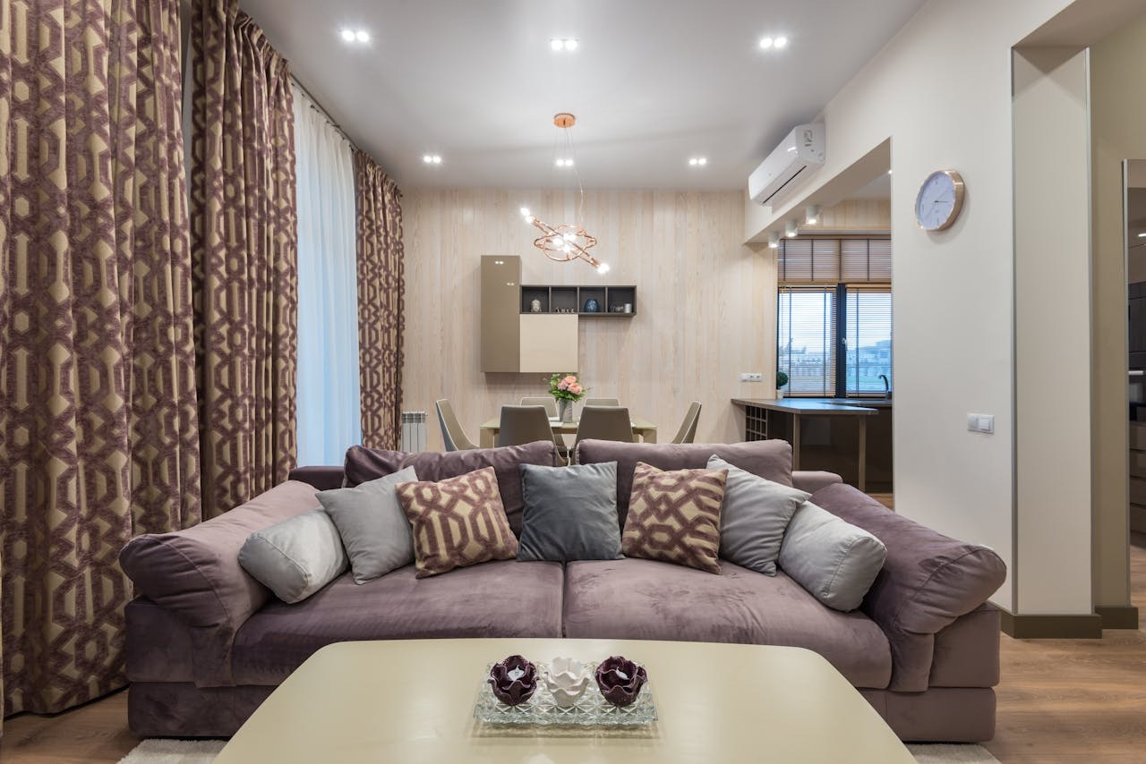 Interior of contemporary living room with soft sofa and decorative cushions